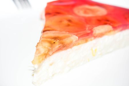 Cottage cheese cake with banana slices and gelatin on isolated backgroundの写真素材