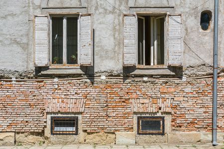 Old brick house facade with windows.の写真素材