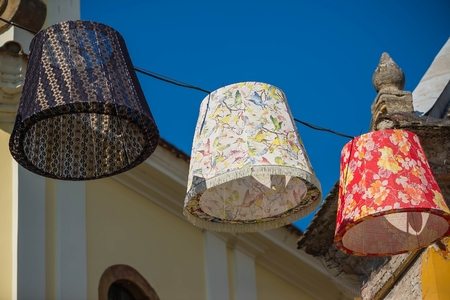 Colorful lanterns hanging on the street against the blue skyの写真素材
