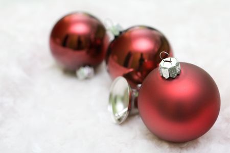 Red christmas balls in a row with a silver bell.の写真素材