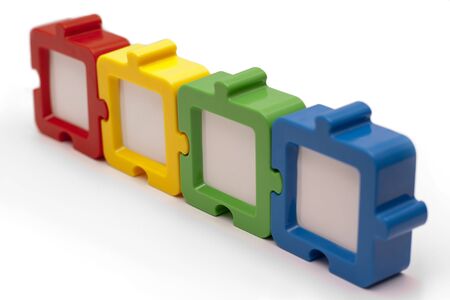 Puzzel photo frames in a row, in various colors, and isolated on white background.の写真素材