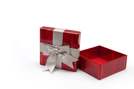 An opened red gift box with white ribbon, for any occasion.の写真素材