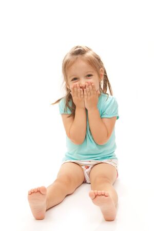 Young girl laughing to the camera on isolated white background.の写真素材