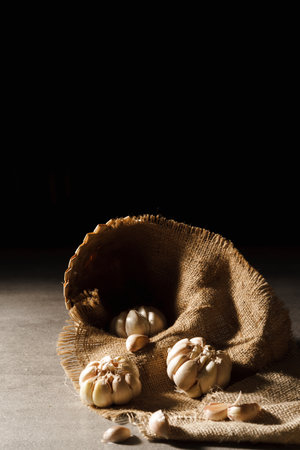 Stacked garlic photographed on the table with dark backgroundの写真素材