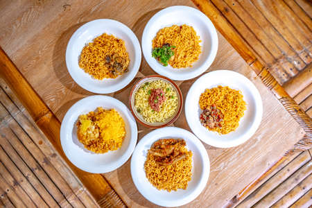 Indonesian instant noodles are served on white plates and arranged in such a way on the table.