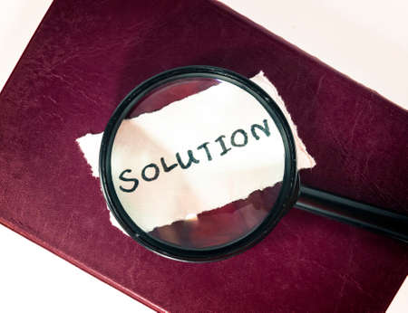 Solution with hand writing on bookの写真素材