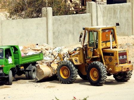 Cairo, Egypt, March 9 2022: heavy yellow bulldozer, grader and excavator construction equipment, end...