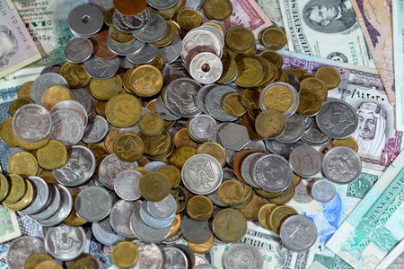 Old Egyptian coins on various old cash money banknotes from different countries of the world, stack...