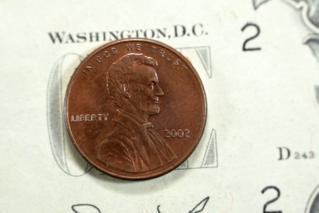 1 One American cent coin series 2002, Obverse side features Abraham Lincoln the 16th president of the United States Of America who preserved the Union, old USA vintage retro coin on USD banknoteの写真素材