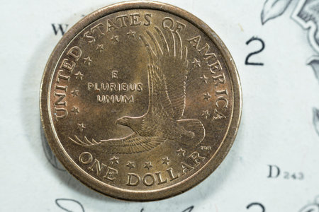 Bald eagle in flight from the reverse side of The golden Sacagawea dollar series 2000, American 1 $ one dollar coin, old USA vintage retro coin on USD banknote, United States Of America Coinageの写真素材