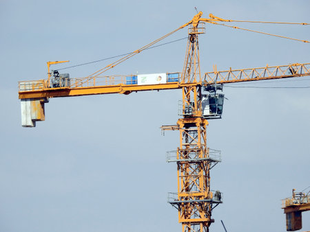 Giza, Egypt, March 28 2021: crane towers at a construction site of new high rise developmental residential buildings in Sheikh Zayed city, selective focus of cranes for new city buildingのeditorial素材