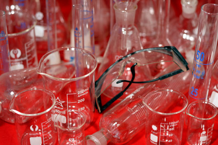 Cairo, Egypt, October 18 2022: A laboratory set of different equipment and glassware, safety goggle, chemical conical, boiling and volumetric flasks, test tubes, funnels, graduated cylinders isolatedのeditorial素材