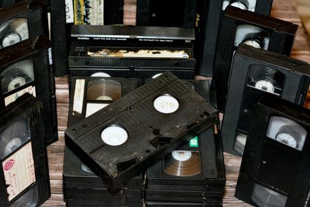 Cairo, Egypt, October 18 2022: pile of VHS video cassette tapes with supply and take up reels and made of plastic that were used on video recorders, retro style vintage old obsolete video tapesのeditorial素材