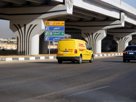 Cairo, Egypt, August 31 2023: DHL truck on its way delivering a package, DHL is the global leader in the logistics industry specializing in international shipping, courier services and transportationのeditorial素材