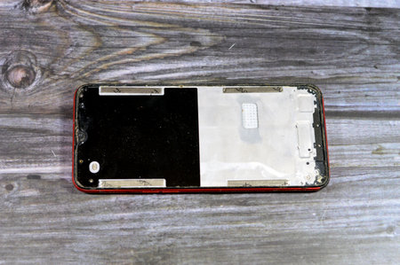 maintenance of a cellular phone mobile with a cracked broken screen, for replacement, cellphone repairing services concept, broken phone, substandard materials, fixation of cellphones, selective focusの写真素材