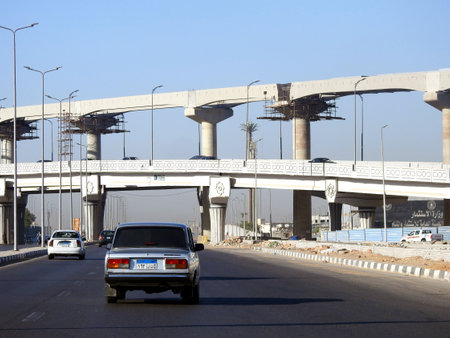 Cairo, Egypt, September 10 2023: A construction site of new projects of traffic bridge and tracks, columns of Cairo monorail railway transport system under construction with scaffolds on the columnsのeditorial素材