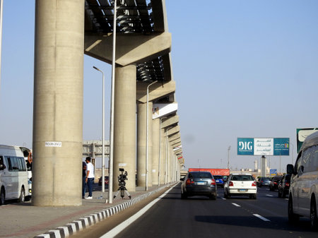 Cairo, Egypt, September 29 2023: Egyptian Media news channel staff with their camera, tripod and equipment, at the sight of Cairo monorail columns and tracks that is still under constructionのeditorial素材