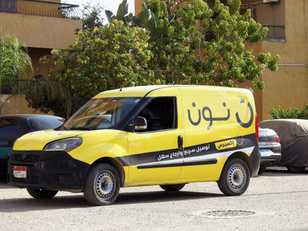 Cairo, Egypt, September 29 2023: Noon online shopping delivery yellow van to deliver a package, Arabic Translation (Noon.com express for fast delivery and easy return), Noon is an e-commerce companyのeditorial素材