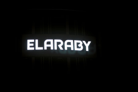 Cairo, Egypt, September 30 2023: The exterior of ElAraby building that is under construction and the group company logo with lights at night, home appliances and electric products, selective focusのeditorial素材