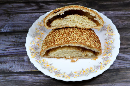 Baked sesame pie stuffed with cinnamon and sugar, Egyptian pie topped with sesame seeds and filled with cinnamon, used as a snack with tea in breakfast, sweet dessert of baked Egyptian goodsの写真素材