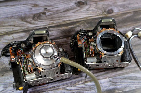 A medical stethoscope on a DSLR photographic and video digital camera body interior repair, camera and technology equipment maintenance and repair concept, old SLR crop sensor mirror Camera fixationの写真素材
