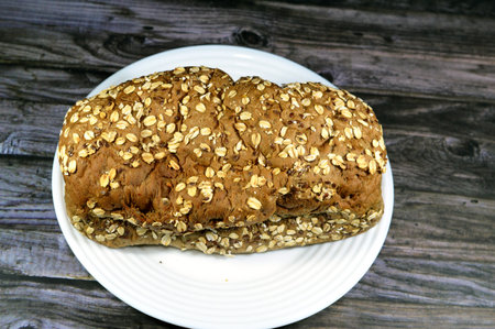 wheat oat fresh baked toast topped with oats and sesame, The oat (Avena sativa), sometimes called the common oat, species of cereal grain grown for its seed consumed as oatmeal and rolled oatsの写真素材