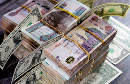 Stacks of Egypt money banknote bills EGP LE thousands of Pounds currency banknotes bill, Egyptian money exchange rate and USA American dollars banknotes bills, economy status, money concept, inflationの写真素材