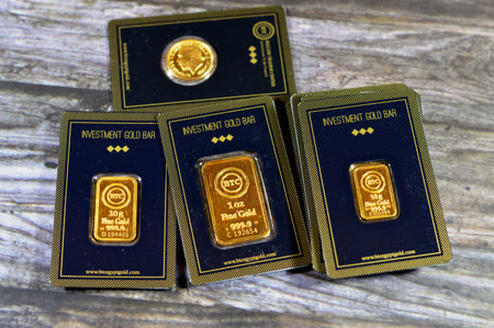 Cairo, Egypt, December 8 2023: 24K karat BTC Bullion Trading Center pure yellow gold of bars and sovereign coin, gold investment, exchange price rate, inflation crisis and saving money assets conceptのeditorial素材