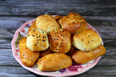 Assorted mini PÃ¢tÃ© with different fillings and toppings, cheese, olive, topped with sesame, black Baraka seeds, Pate is a paste, pie or loaf filled with a forcemeat, vegetables, herbs, spices, cheeseの写真素材
