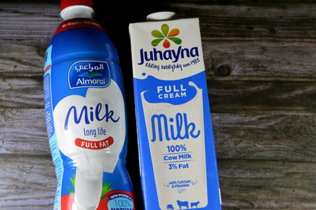 Cairo, Egypt, December 16 2023: Almarai full fat creamy fresh cow's milk with no preservatives, no powder with Vitamin D, Juhayna full cream fresh cow's milk carton with Calcium and vitaminsのeditorial素材