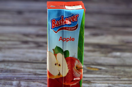Cairo, Egypt, January 2 2024: Bashayer apple fruit drink, Apple juice is a fruit juice made by the maceration and pressing of an apple, sweetened apple juice drink, selective focusのeditorial素材
