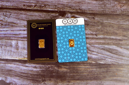 Cairo, Egypt, January 2 2024: BTC Bullion Trading Center and SAM precious metal 24K karat pure yellow gold 1 gram bars, gold investment, exchange price rate, inflation crisis and saving money assetsのeditorial素材