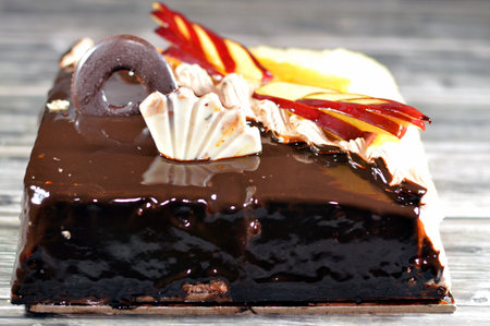 Birthday cake of two halves different pieces spongy creamy cake for celebrations, dark chocolate,...