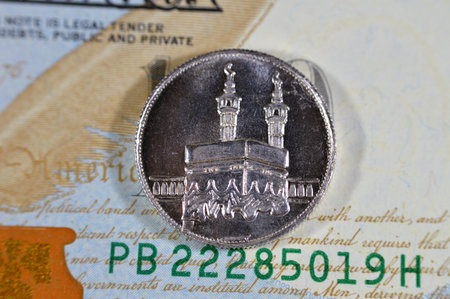A close up of an Islamic pound coin of pure precious silver metal features Kaaba and Masjid Al Haram...