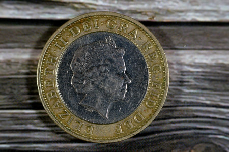 Two British sterling pounds 1998 coin features queen Elizabeth ii on the obverse and Four concentric circles representing the Iron Age, Industrial Revolution, silicon chip and the internet on reverseの写真素材