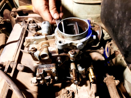 maintenance of a vintage old automobile car, replacements of some car components like spark plug, service for radiator, distributor, engine, air filter, alternator, battery, old car servicesの写真素材