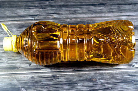 Food table oil, mixture of sunflower, corn, soybean and natural oil that has multi uses in kitchen in cooking various food and in frying many cuisines, table oil in a bottle, selective focusの写真素材