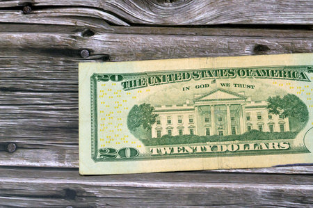 reverse side of 20 dollars portrait, twenty American dollars banknote background, United States dollars banknote USD with the photo of the white house on a wooden background, selective focusの写真素材