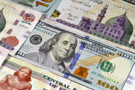 USD American cash of 100 dollars and Egyptian money banknotes of 200 EGP LE two hundred pounds bills, money exchange rates of Egypt and United states of America, inflation and economy conceptの写真素材