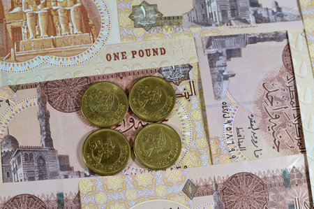 50 fifty piasters EGP coin, Commemorative issue, 50 years on October Victory Golden Jubilee, with Soldiers on Boat holding flag in center, October victory Egyptian coin on 1 LE pound banknoteの写真素材