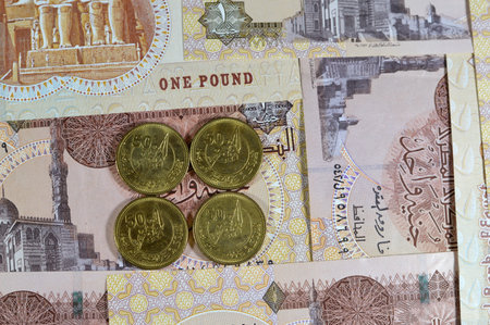 50 fifty piasters EGP coin, Commemorative issue, 50 years on October Victory Golden Jubilee, with Soldiers on Boat holding flag in center, October victory Egyptian coin on 1 LE pound banknoteの写真素材