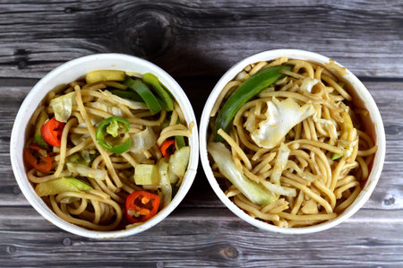 Traditional noodles with onions, soy sauce and spices, bell peppers and chili peppers, selective focusの写真素材