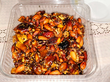 pressed black dates Agwa or Ajwa without kernels with almond and sesame seeds and mixed with ghee, date fruits is a traditional snacks in Ramadan and feast, Ramadan month and Eid celebration conceptsの写真素材