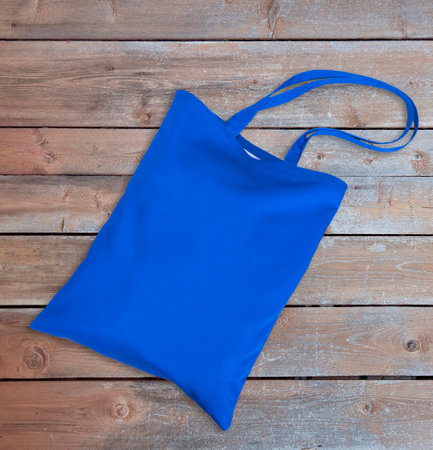 Blue tote bag canvas for shopping eco bag. on wooden table.の写真素材