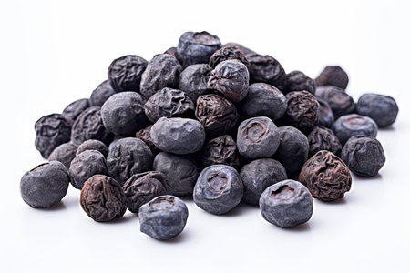 Pile of dried blueberries isolated on white background. Studio shot.の素材