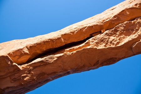 Looking straight up at a crack in North Window sandstone arch located in Arches National park, Utahの写真素材