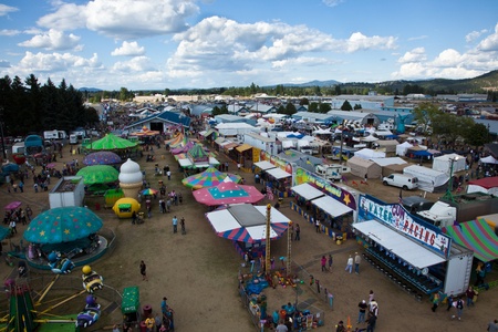 Coeur d'Alene, ID - August 29, 2010: People are enjoying the games, rides and the nice summer weather at The North Idaho Fair and Rodeo as seen from the top of the ferris wheel in Coeur d'Alene, Idaho.のeditorial素材