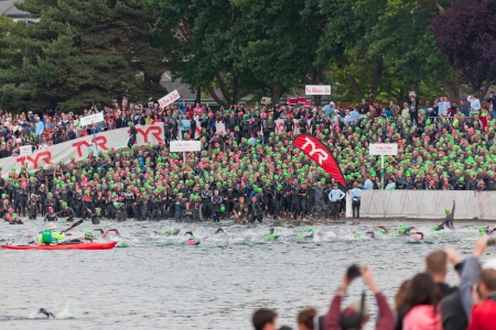 COEUR D ALENE, ID - JUNE 23:   Swimmers going into the water and in the holding area at the start of the June 23, 2013 Ironman Triathlon in Coeur d'Alene, Idaho.のeditorial素材