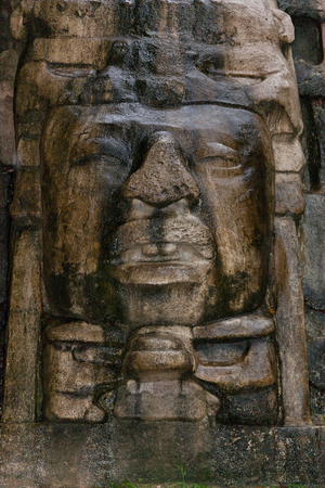 Close up of an Olmec style face that adorns the side of the Mask Temple at the Mayan site of Lamanai in Belize.の写真素材