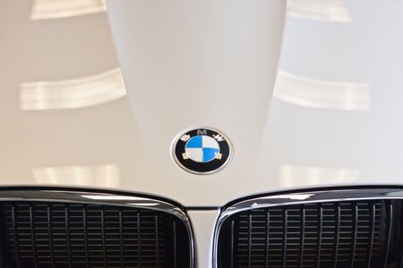 SPOKANE, WA - September 26:  A close up of the emblem on the hood of a white BMW car with part of the grill and light reflecting from the showroom on September 26, 2011 in Spokane, WA.のeditorial素材
